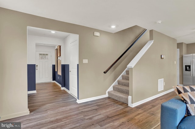 interior space featuring visible vents, stairs, baseboards, and wood finished floors