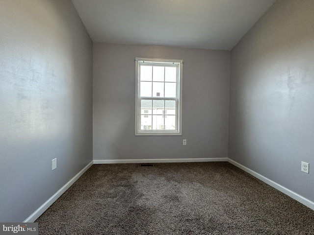 spare room with carpet floors and baseboards