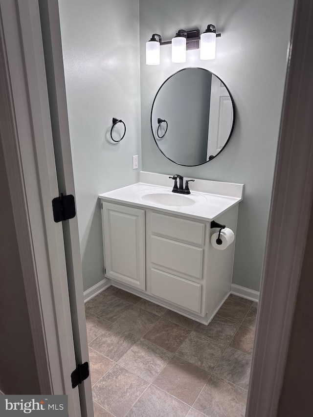 bathroom with baseboards and vanity