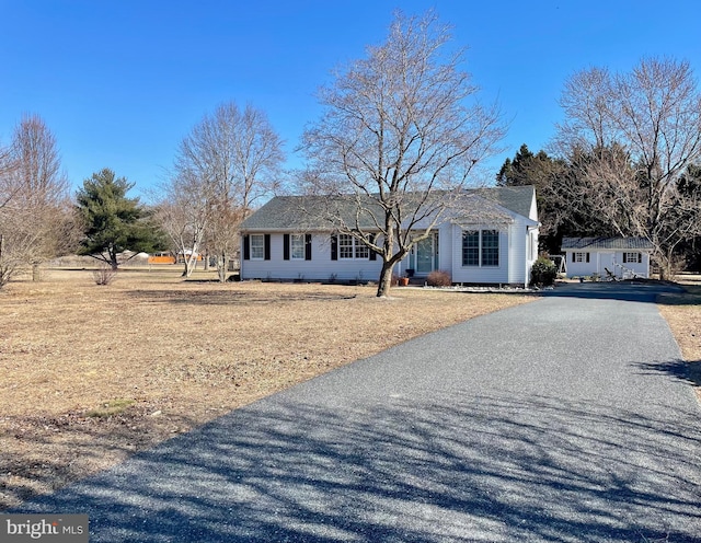 ranch-style home with aphalt driveway