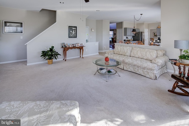 carpeted living area with baseboards