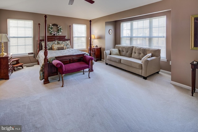 bedroom featuring a ceiling fan, light carpet, and baseboards