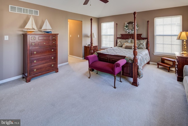 bedroom with baseboards, multiple windows, visible vents, and light colored carpet