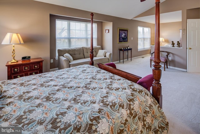 carpeted bedroom with vaulted ceiling and baseboards