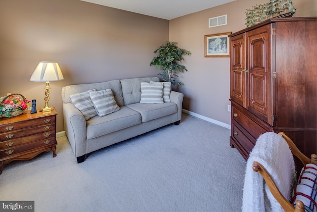 living room with baseboards, visible vents, and light colored carpet