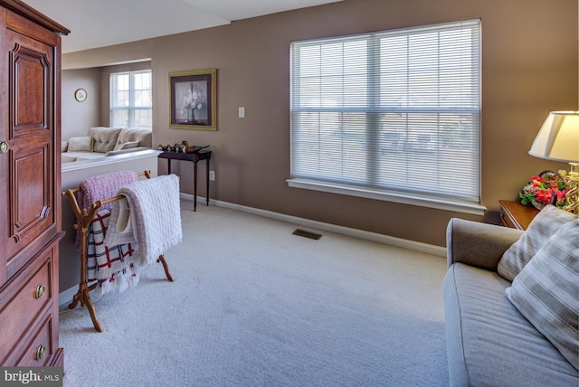 bedroom with light colored carpet, visible vents, and baseboards