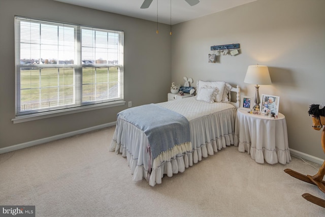 carpeted bedroom with ceiling fan and baseboards