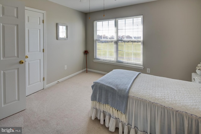 carpeted bedroom featuring baseboards