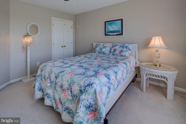 bedroom featuring a closet, carpet flooring, and baseboards