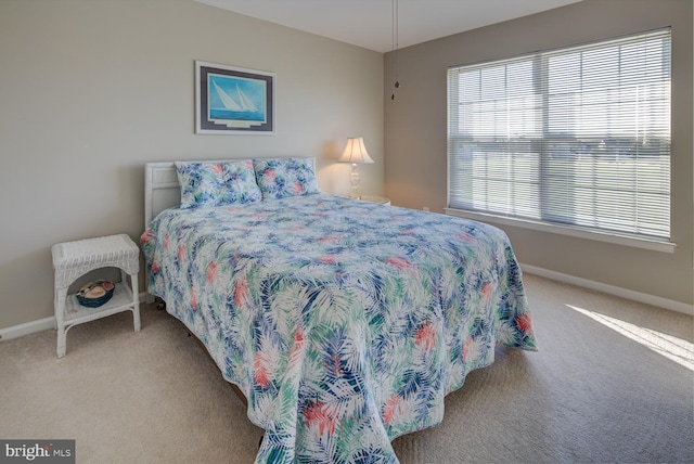 carpeted bedroom featuring baseboards