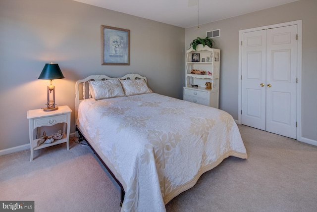 bedroom featuring baseboards, a closet, visible vents, and carpet flooring