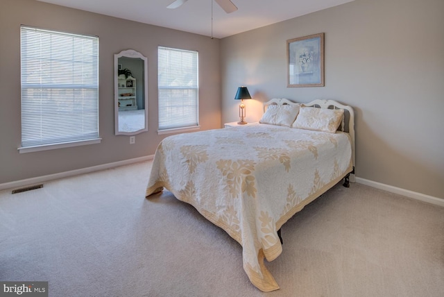 bedroom featuring a ceiling fan, carpet flooring, visible vents, and baseboards