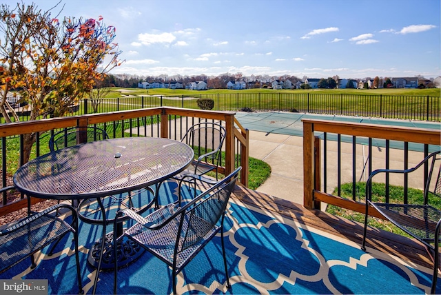 deck with outdoor dining space and fence