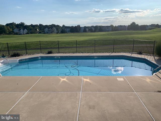 view of pool featuring a yard, fence, and a fenced in pool