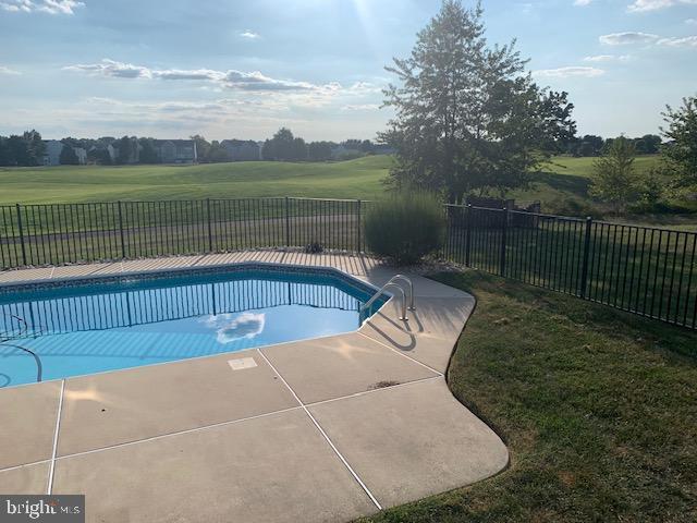 view of pool featuring a patio area, a fenced backyard, a fenced in pool, and a yard