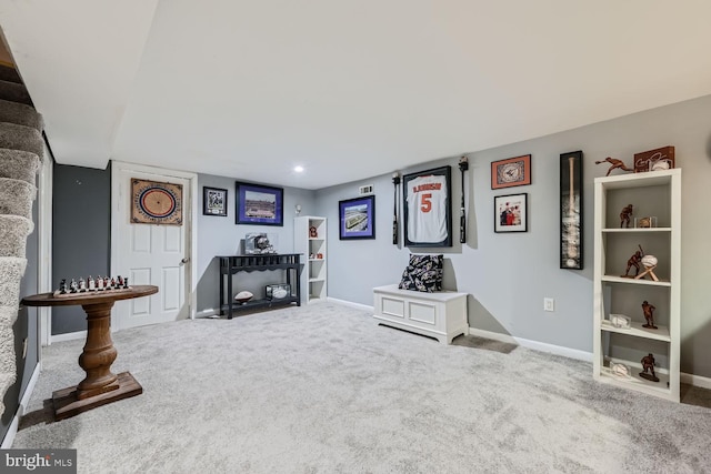 living area featuring baseboards and carpet flooring