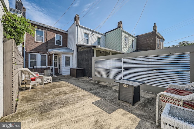 back of property with a patio area and fence