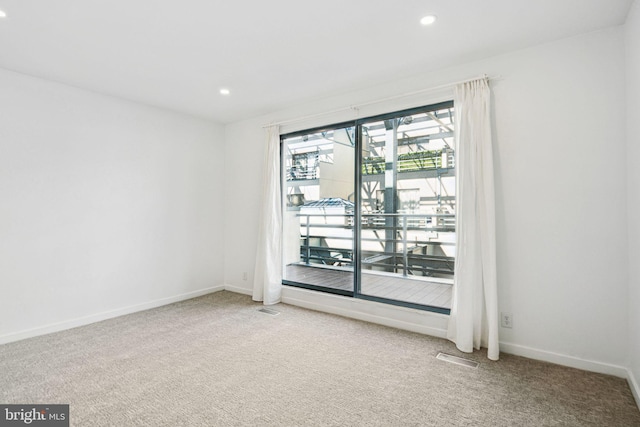 carpeted spare room with recessed lighting, visible vents, and baseboards