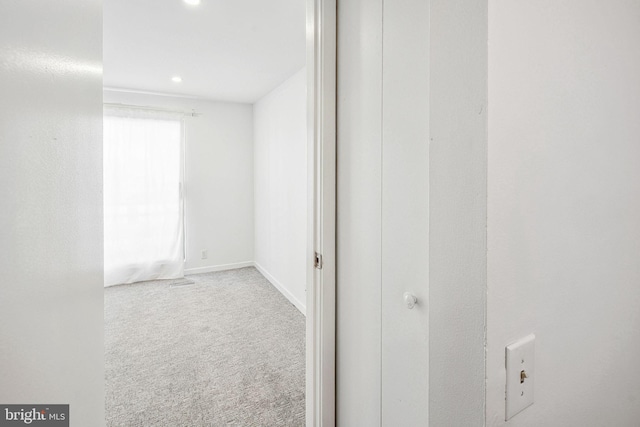 corridor with carpet floors, recessed lighting, and baseboards