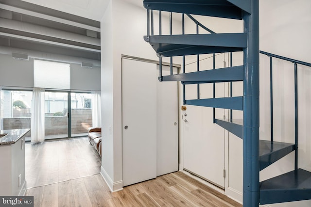 interior space with wood finished floors and visible vents