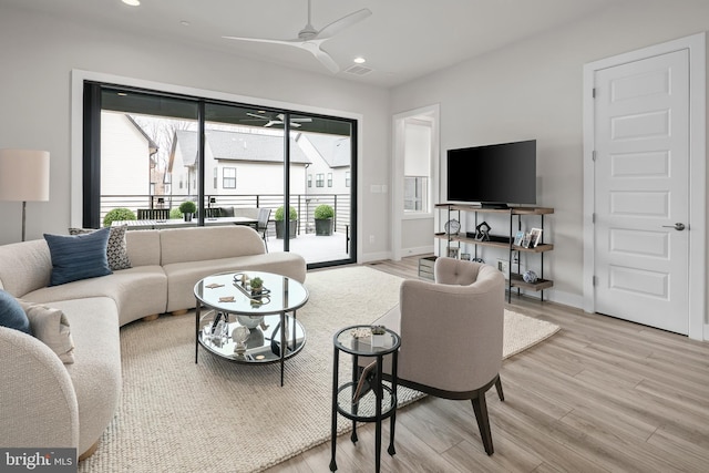 living room with recessed lighting, baseboards, ceiling fan, and wood finished floors