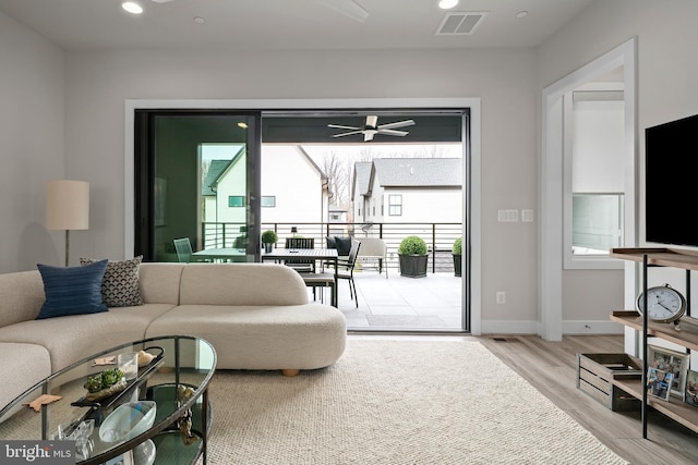 living area featuring visible vents, recessed lighting, baseboards, and wood finished floors