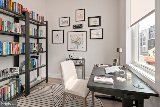 home office featuring baseboards and wood finished floors