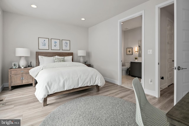 bedroom featuring recessed lighting, connected bathroom, light wood-type flooring, and baseboards