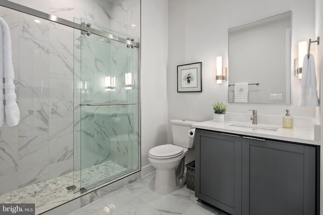 full bath with a marble finish shower, marble finish floor, toilet, and vanity