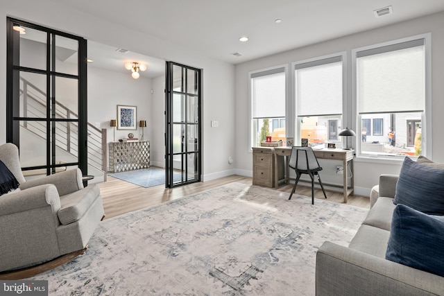 office area with recessed lighting, visible vents, light wood-style flooring, and baseboards