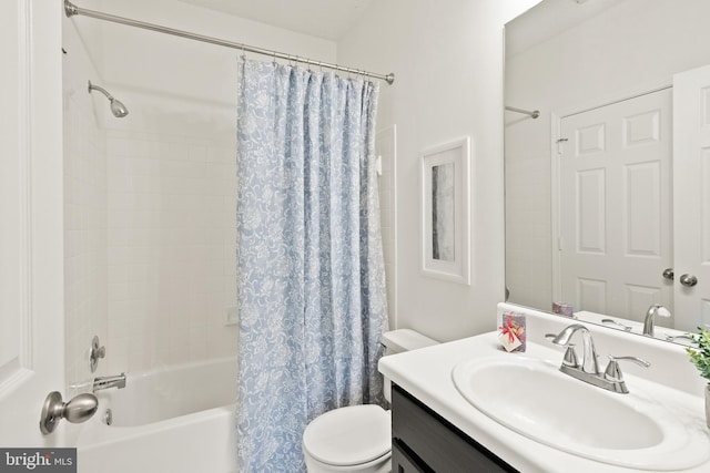 bathroom featuring vanity, shower / bath combo, and toilet