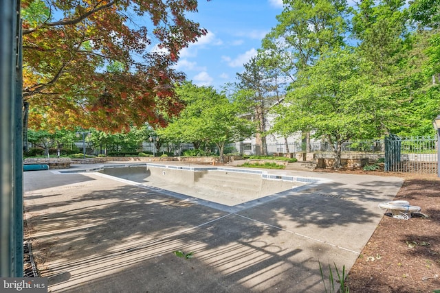view of pool featuring fence