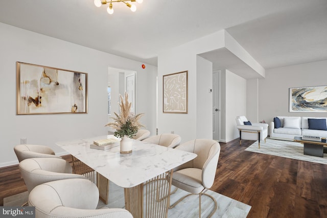 dining space featuring dark wood finished floors and baseboards