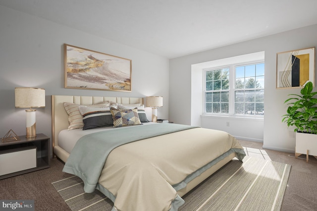 carpeted bedroom featuring baseboards