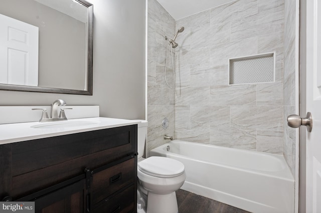 full bathroom with vanity, wood finished floors, bathtub / shower combination, and toilet