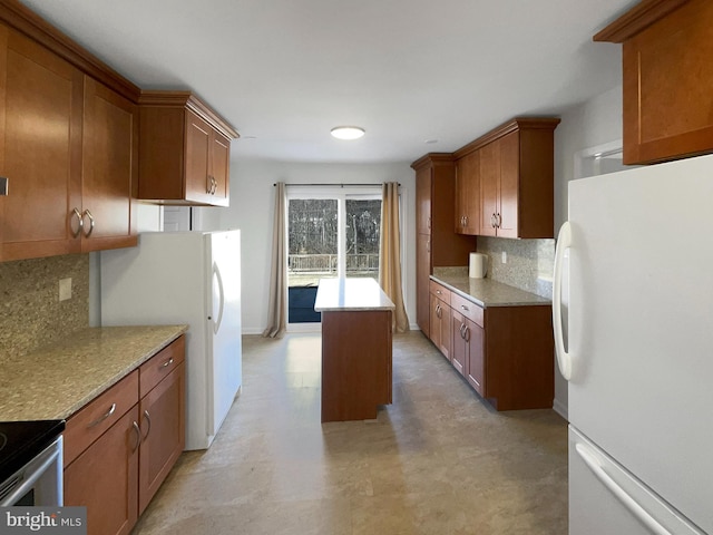 kitchen featuring brown cabinetry and freestanding refrigerator