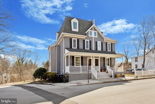 view of front of property featuring a porch and roof with shingles