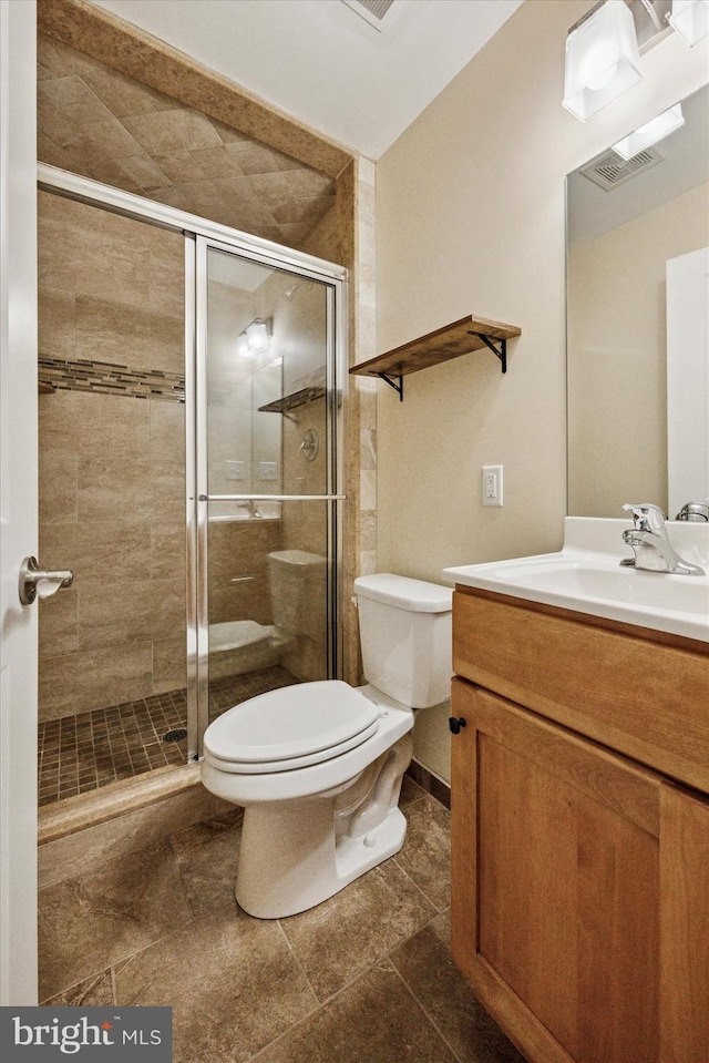 full bathroom featuring toilet, a stall shower, visible vents, and vanity