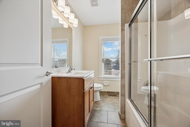 full bath featuring a wealth of natural light, visible vents, vanity, and toilet