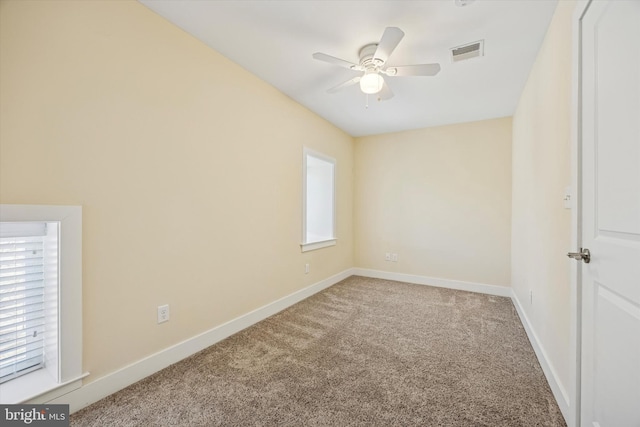 empty room with a ceiling fan, baseboards, visible vents, and carpet flooring