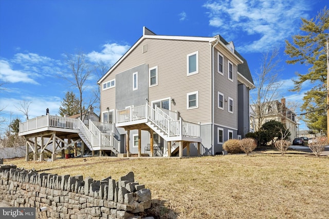 back of house with a yard, stairway, and a wooden deck