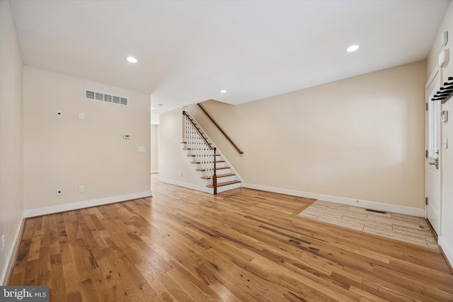 foyer entrance with recessed lighting, visible vents, stairway, and light wood finished floors