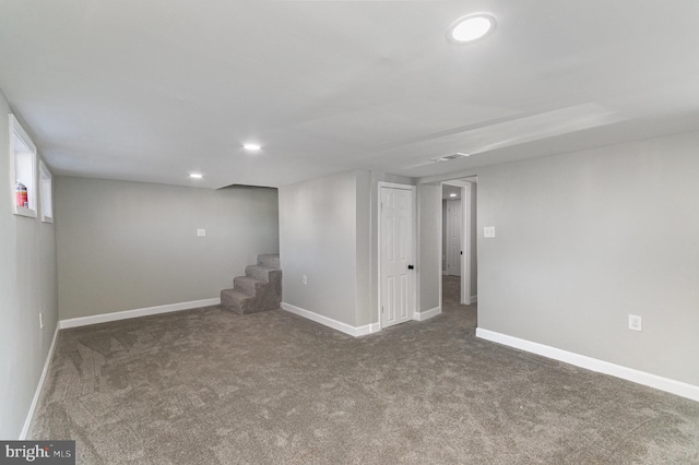 finished below grade area with carpet floors, baseboards, stairway, and recessed lighting