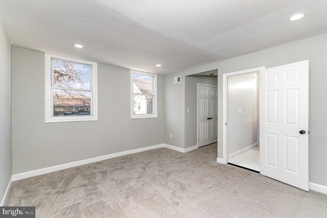 unfurnished bedroom with carpet, visible vents, baseboards, and recessed lighting