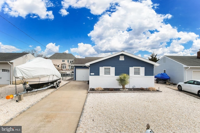 view of front of property with a garage, concrete driveway, and brick siding