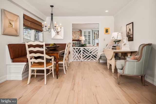 dining area featuring baseboards, ornamental molding, hardwood / wood-style flooring, and an inviting chandelier