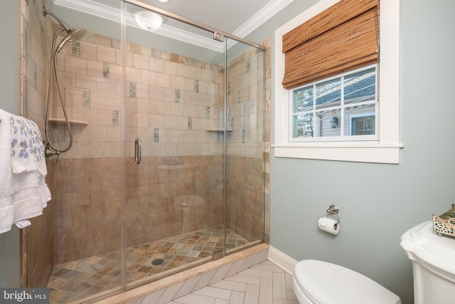 bathroom with toilet, a shower stall, ornamental molding, and baseboards