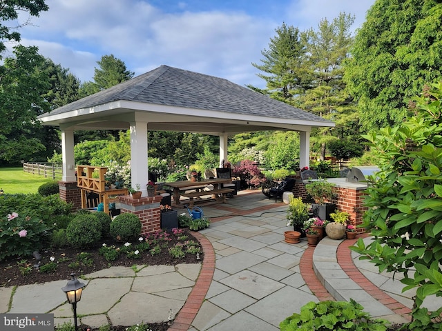 view of home's community with a gazebo, a patio area, and an outdoor kitchen
