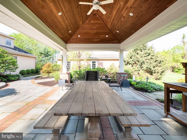 view of patio / terrace with outdoor dining area, a gazebo, and a ceiling fan