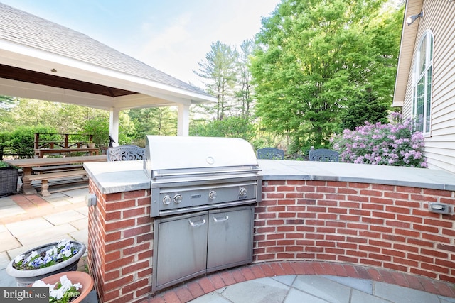 view of patio / terrace with a grill, a gazebo, and area for grilling